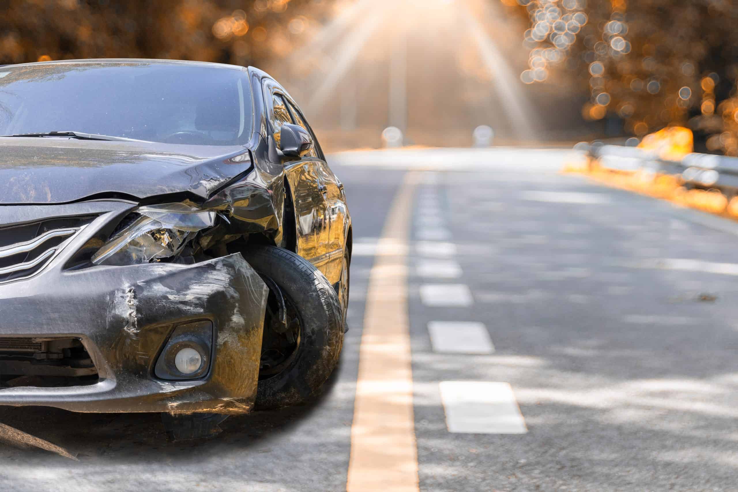 Artumn road Front of black color car big damaged and broken by